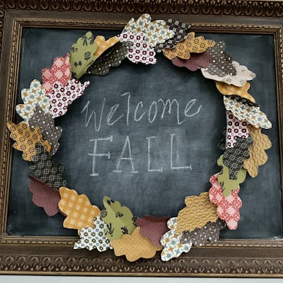 paper leaf wreath on a chalkboard that says welcome fall