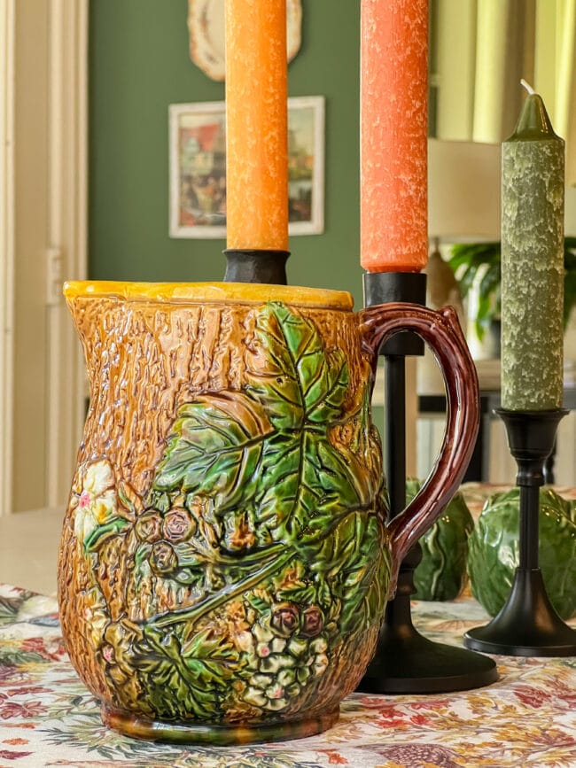 vintage Majolica pitcher with fall candles in background.
