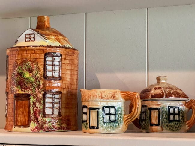 vintage cookie jar shaped as a round house with a matching cream and sugar bowl