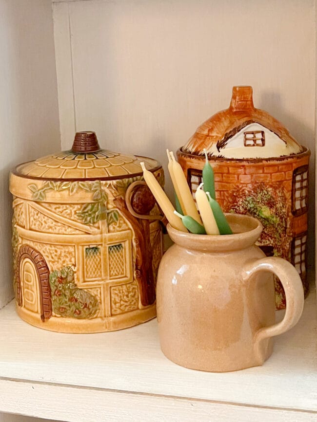 2 gold vintage jars and small candles inside a small pitcher