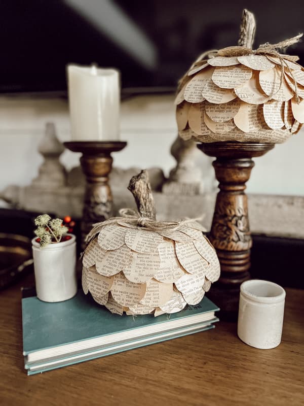 two book page pumpkins on candlesticks
