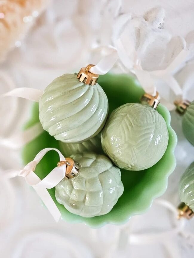 3 jadeite looking ornaments in a greet bowl