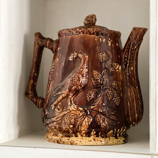 large vintage brown ale pitcher with a bird and acorns on the outside