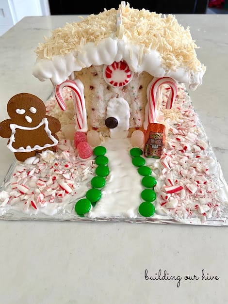 poptart gingerbread house with candy canes and gingerbread cookie