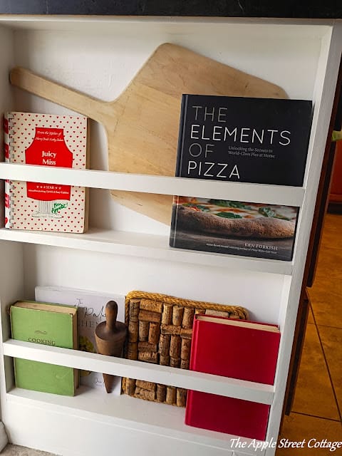 white bookshelf on side of cabinet 