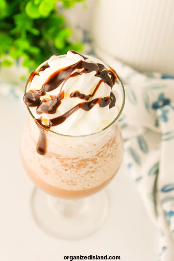 Glass with frozen hot chocolate and drizzle on top.