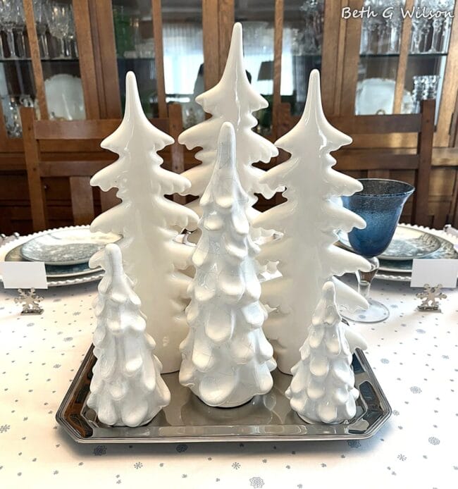 white ceramic trees as a centerpiece on a tablescape