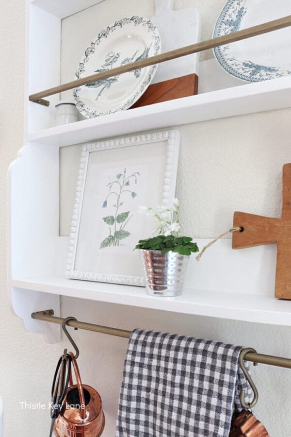 white wall shelf with spring print and plates