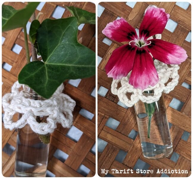 two clear glass vials with crocheted trim and flowers inside 
