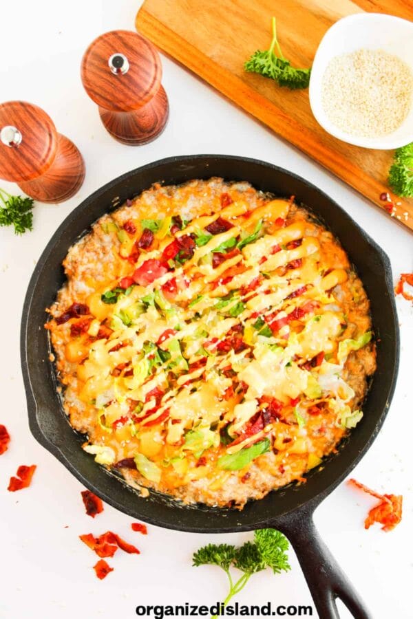 cast iron skillet with cheeseburger dip inside
