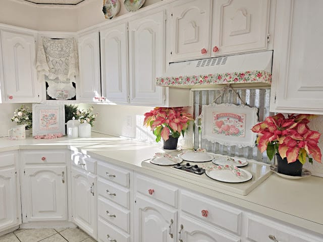 white kitchen with Valentine's decor and pink poinsettias. 