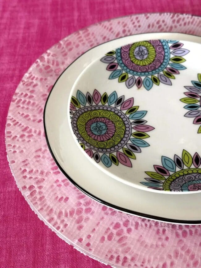 stacked pink plates and salad place with purple design