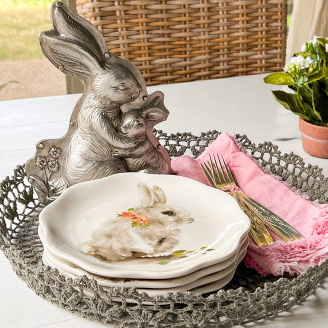 silver bunny mold with bunny plates, pink napkins and silverware