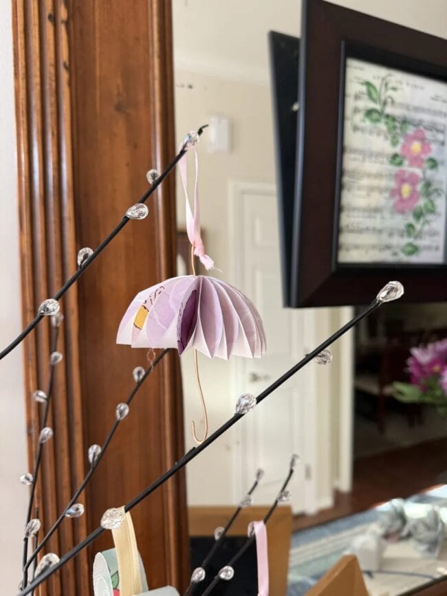 a tiny lavender umbrella hanging on a stem