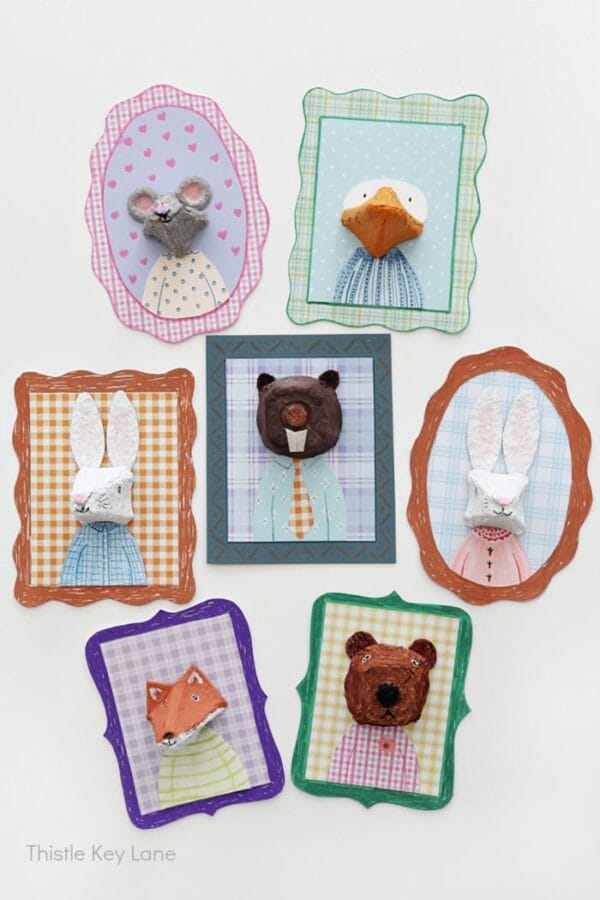 7 framed pieces of animal artwork made from egg cartons. All bright colors and patterns.