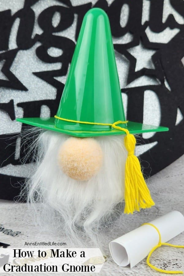 a handmade gnome with a green hat and yellow graduation tassel