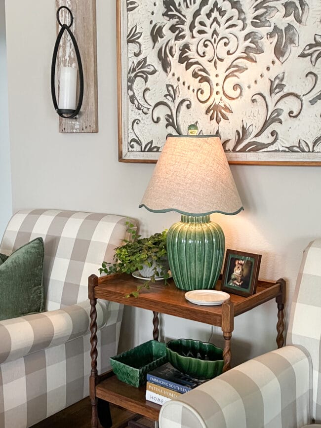 checked chairs with vintage wooden in between, a green lamp and plant