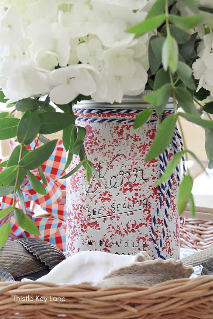 Red and white sponged mason jar in a centerpiece