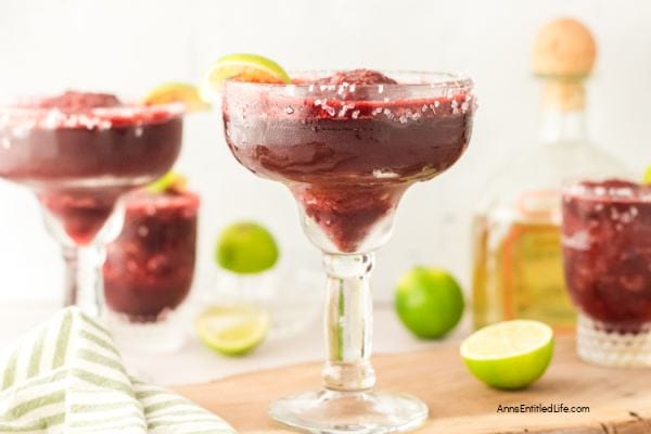 dark red margarita in a glass with a lime