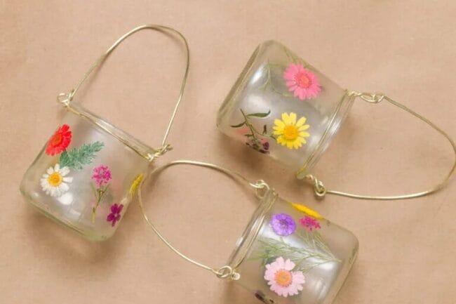 3 clear mason jar lanterns with pressed flowers