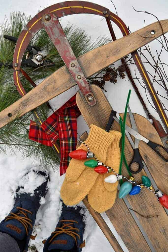 vintage wooden sleigh with snow, mittens and gold mittens