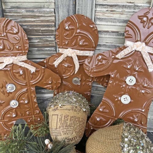 3 brown tin cutouts of gingerbread men 