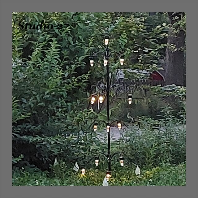 solar light tree standing among natural bushes and trees