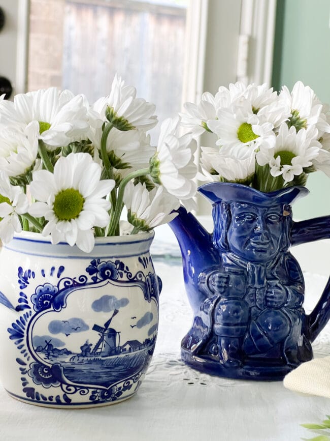 vintage blue and white pot and a blue Toby pitcher with white daisies