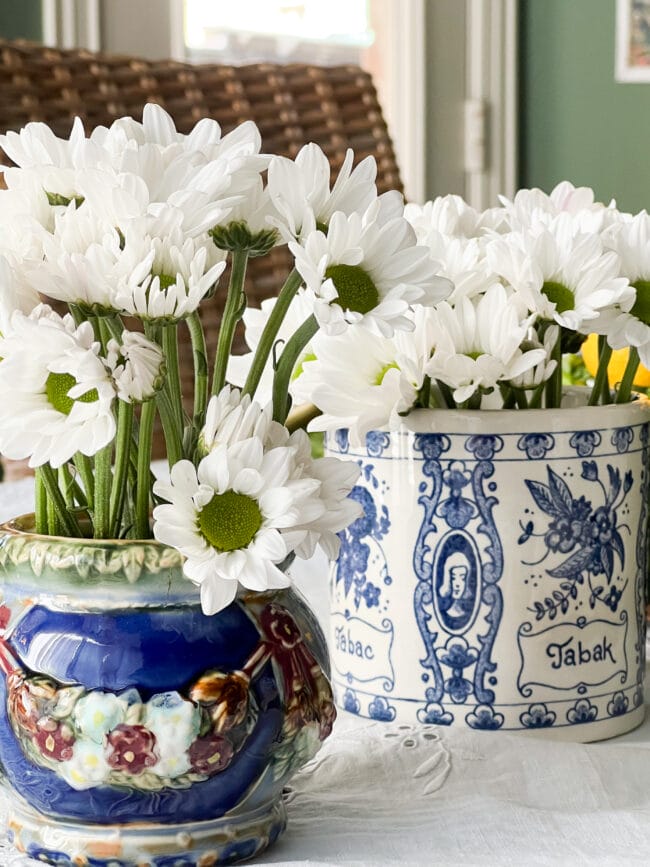 blue and white vintage pots with white daisies