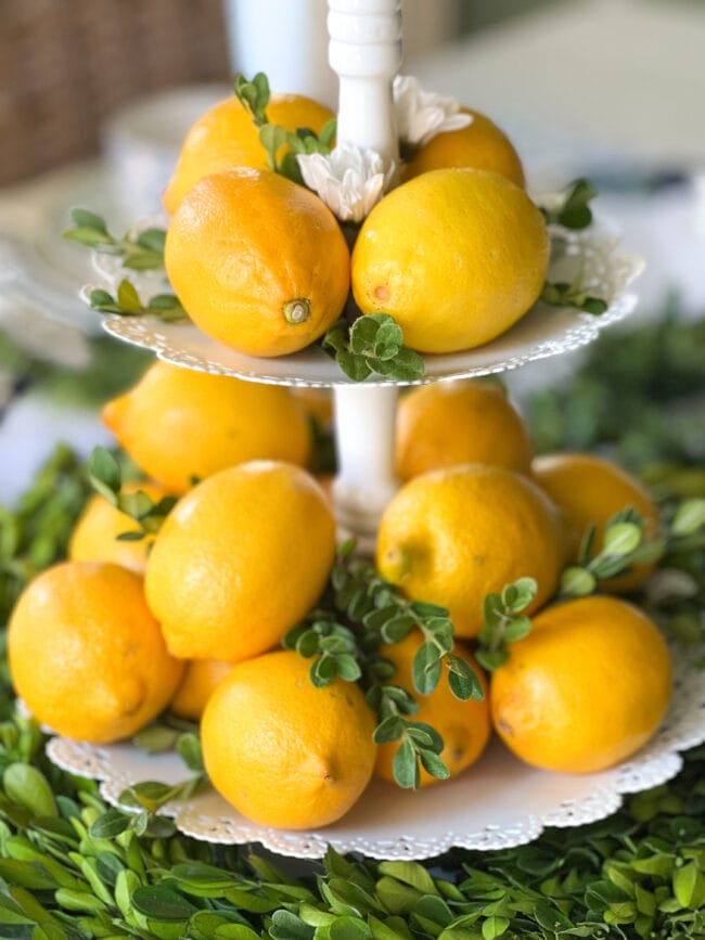 close up of two tiered tray of lemons with real boxwood clippings