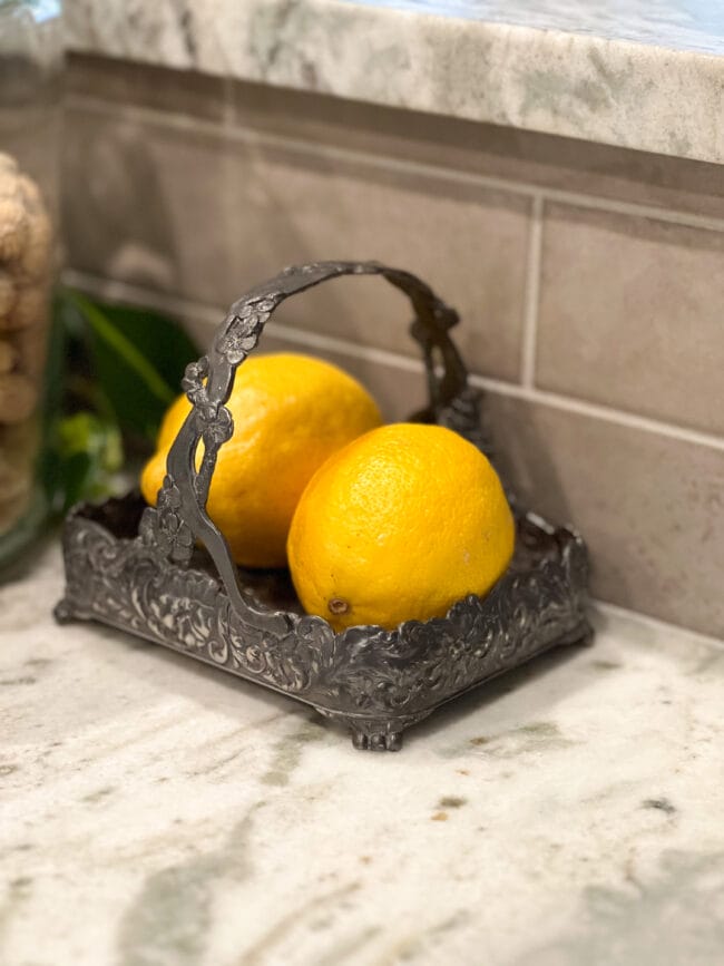 two lemons in a vintage silver dish with handle