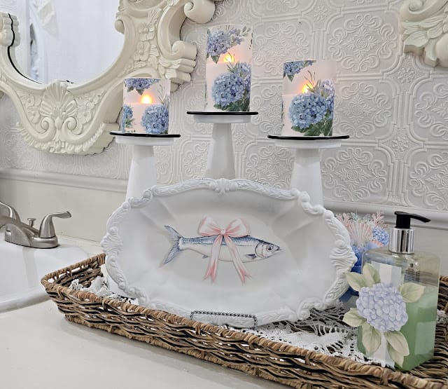 white tray decorated with a fish decal and 3 blue and white candles behind it