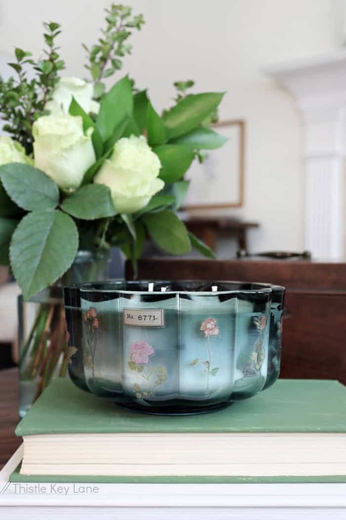 teal blue glass candle with floral stickers