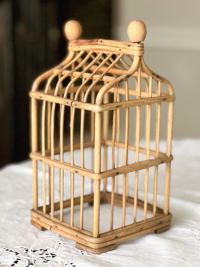 bamboo cage on white tablecloth