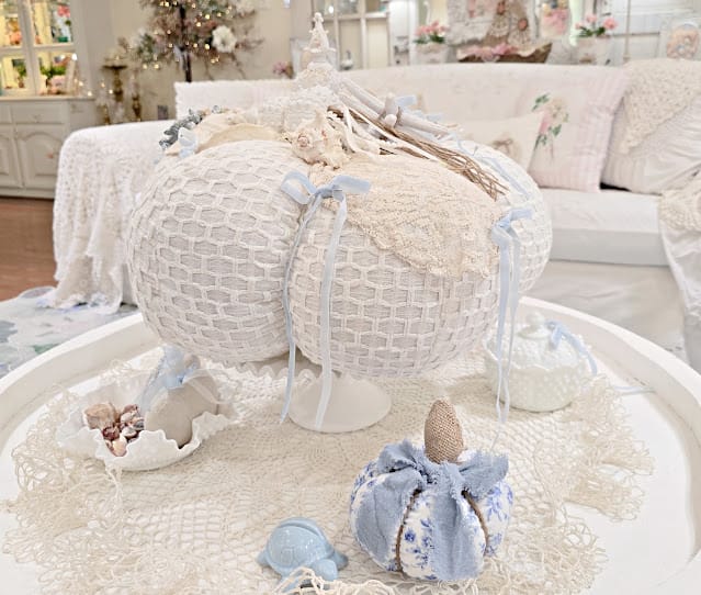 white crocheted pumpkin with coastal decor on a white tray