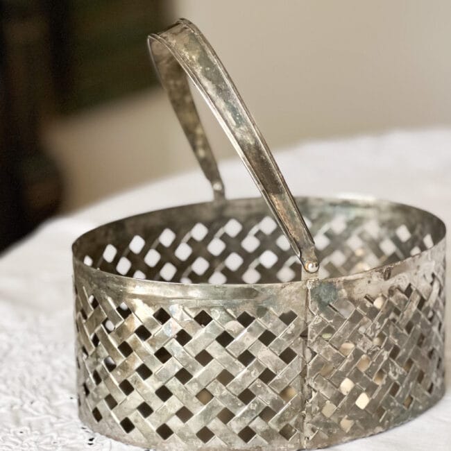 silver plated basket with handle on a white tablecloth