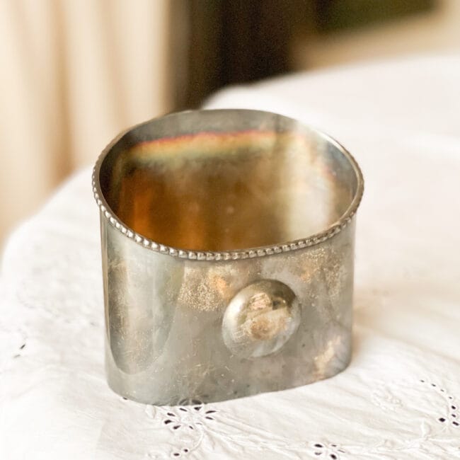 silver mail holder on a white tablecloth
