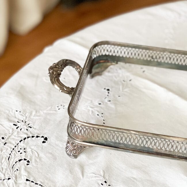 silver plated casserole holder on a white tablecloth