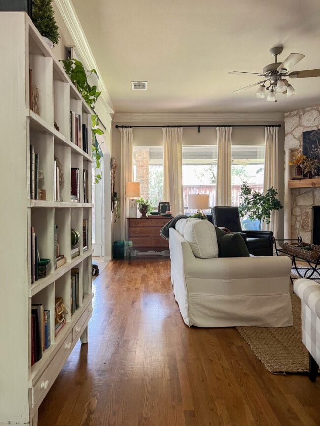 view of windows, bookshelves and white sofa from far away