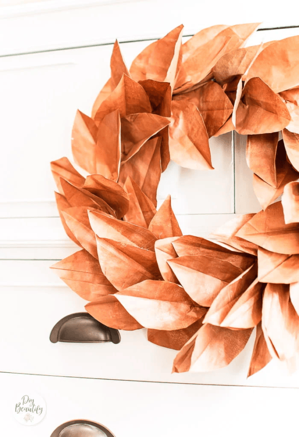 up close of a paper leaf wreath made to look like a magnolia leaf wreath
