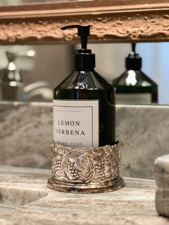 silver plated wine bottle holder used to hold a bottle of soap