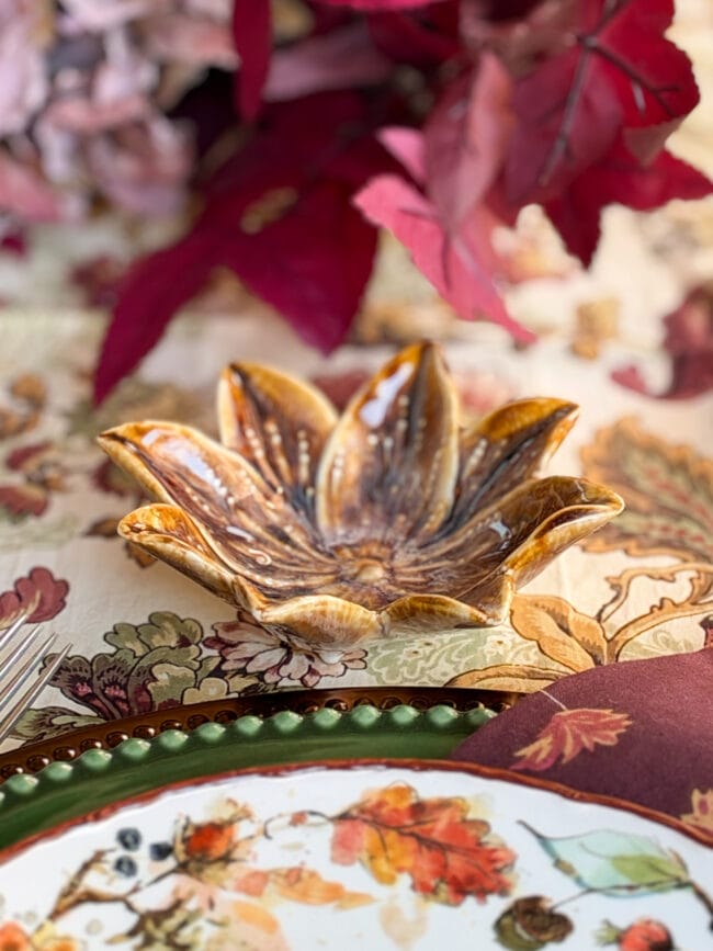close up of a gold ceramic dish shaped like a poinsettia flower