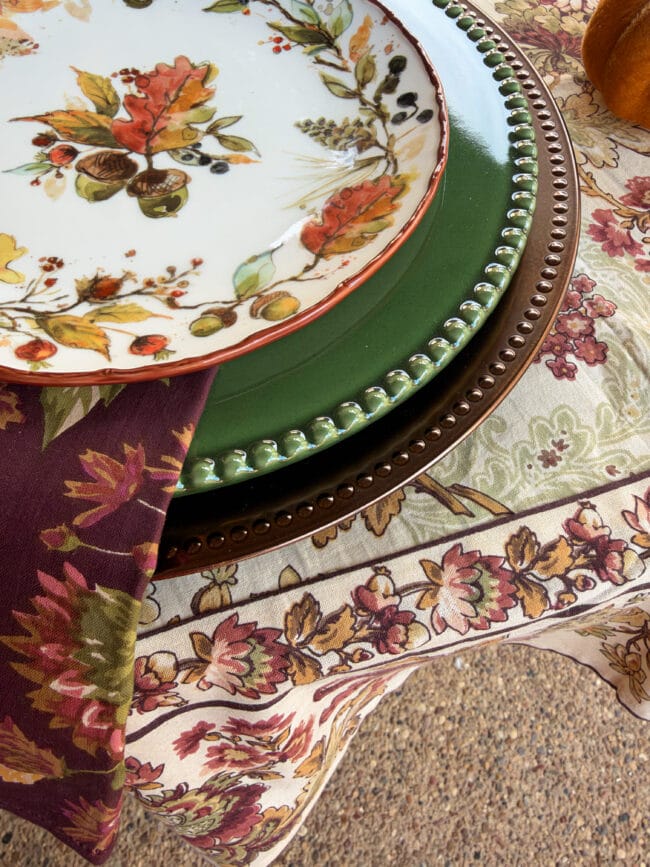 close up photo of layered fall dishes with a tablecloth