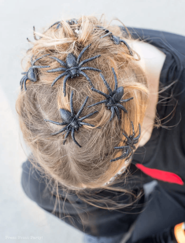 girls head with faux spiders 